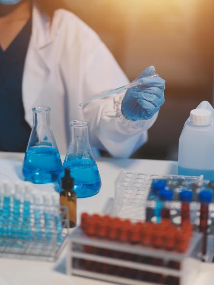 Group of dedicated scientist conduct chemical experiment in medi Group of dedicated scientist conduct chemical experiment in medical laboratory, carefully drop precise amount of liquid from pipette into test tube for vaccine drug or antibiotic development. Neoteric